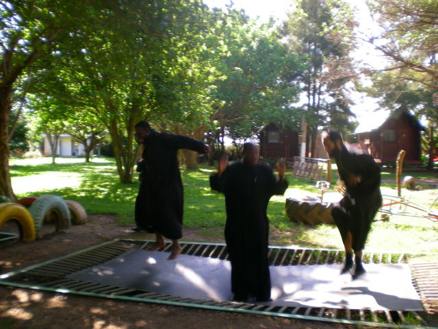 Coptic Priests in Africa spending some of their free time jumping on a trampoline.